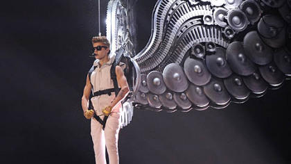 Teen throb Justin Bieber opens the show before a sellout crowd with "All Around the World."