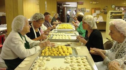 Tami Dixon, at center right, joins the pierogi production line at St John the Baptist Ukrainian Catholic Church, South Side, and engages in conversations that helped her form the script for "South Side Stories."