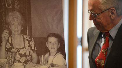 Jim Temple, grandson of Virginia O'Hanlon, looks over a photo of himself as a child with his grandmother before speaking Friday at Carnegie Mellon University for the kickoff of the Toys for Tots campaign.