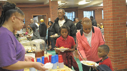 Residents take part in a community dinner Saturday at the Warrington Recreation Center.