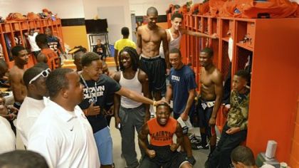 Senior Vinny Moody, 18, center, hypes up his Bears teammates before a home game Oct. 26 against Imani Christian Academy. Moody and other members of the team wrote a rap about their predicted defeat of the Saints. Players listened to the song for hours before kickoff.