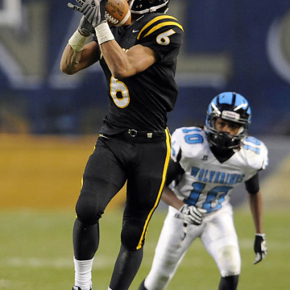 North Allegheny's Elijah Zeise pulls in a pass in front of Woodland Hills' Khalil Harper Friday in the WPIAL class AAAA championships at Heinz Field.
