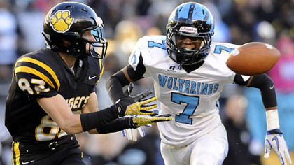 North Allegheny's Gregg Garrity pulls in a pass for a touchdown as he's defended by Woodland Hills' Daechaud Ausbrooks Friday in the WPIAL class AAAA championships at Heinz Field.