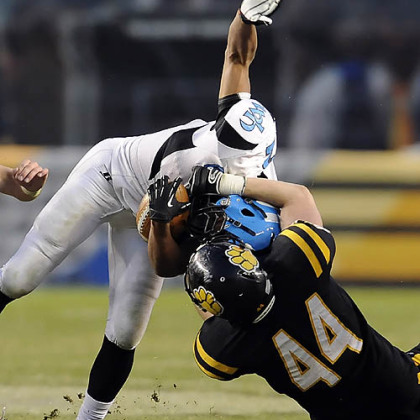 North Allegheny's Kevin Edwards takes down Woodland Hills' Dequan White Friday in the WPIAL class AAAA championships at Heinz Field.