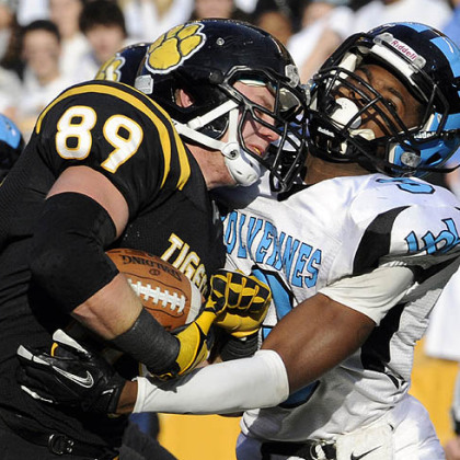 North Allegheny's Zach Lyon runs into the end zone for a touchdown as he's defended by Woodland Hills' Trevon Mathis Friday in the WPIAL class AAAA championships at Heinz Field.
