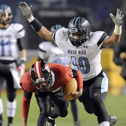 Aliquippa's Malik Shegog carries as he's defended by Washington's Jaylin Kelly Friday in the WPIAL class AA championships at Heinz Field.