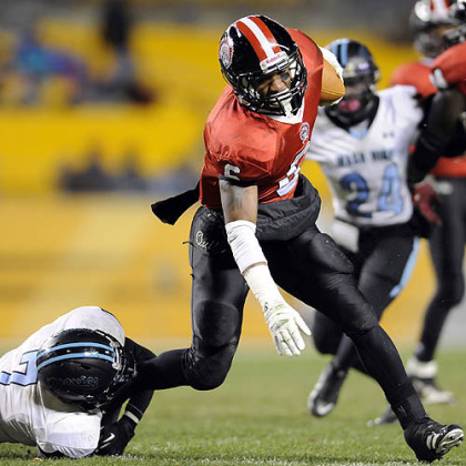 Aliquippa's Dravon Henry carries as he's defended by Washington's Mijerean Witcher Friday in the WPIAL class AA championships at Heinz Field.