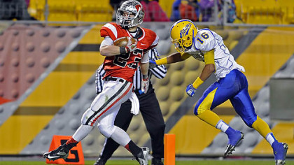 West Allegheny's Chayse Dillon carries for a touchdown as he's defended by West Mifflin's Jarod Wright at tonight's WPIAL class AAA championship game at Heinz Field.