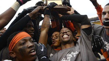 The Bears hold their WPIAL Championship trophy up after their 58-21 win against Sto-Rox Friday at Heinz Field.  The Bears broke a state record, winning their 60th consecutive game.