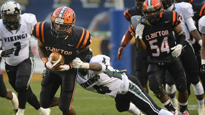 Clairton Junior Terrish Webb carries the ball while Shakelford Ben attempts the tackle Friday at Heinz Field. The Bears set a Pennsylvania record with its 60th consecutive victory, a 58-21 win against Sto-Rox in the WPIAL Class A title game.
