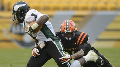 Titus Howard lunges at Vikings quarterback Lenny Williams Friday at Heinz Field.
