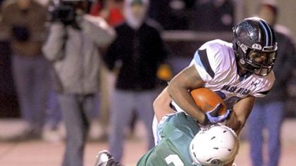 Washington's Shai McKenzie, scoring a touchdown despite the effort of South Fayette's Dylan Nock in a WPIAL Class AA semifinal last Friday, has 10 200-yard rushing games this season.