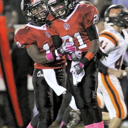 Aliquippa's Terry Swanson, left, congratulates teammate Shaquere McBride on scoring the first touchdown of the game Oct. 18 against Beaver Falls.