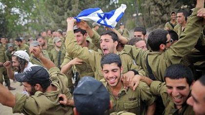 Israeli soldiers dance Thursday to music provided by Hassidic Jews who visited to show their support to soldiers at the border with the Gaza Strip.