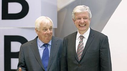 Tony Hall, right, the new director general of the BBC, and Chris Patten, the head of the BBC Trust, joke before a news conference Thursday in London.