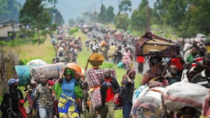 Thousands of Congolese flee the town of Sake, west of Goma, following fresh fighting in the eastern Democratic Republic of the Congo town Thursday. Fighting broke out that afternoon, causing people to flee the town and head to camps for the internally displaced in the village of Mugunga.