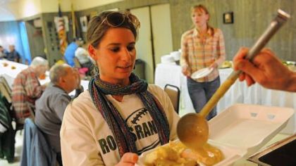 Volunteer Lindsay Mobrey of Robinson prepares a take-out order Thursday at the Sto-Rox American Legion Post 618's 10th annual free Thanksgiving dinner in McKees Rocks. Volunteers served about 600 dinners, including home delivery to seniors in the community. Many business and restaurants donated the food and money to make the dinner possible.