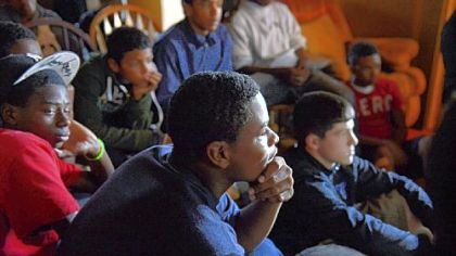 From left, Taymier Jamison, 13, Harrison Dreher, 14, and Daniel Payo, 14, review film from one of their Midget football games in October at coach Corey Wright's house. "There is only one thing to be in Clairton if you are a boy ... a Bear," Wright says.