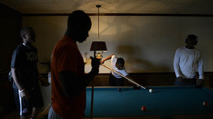Members of the Clairton Bears shoot pool at Hot Towels And Sharp Razors barber shop on St. Clair Avenue.
