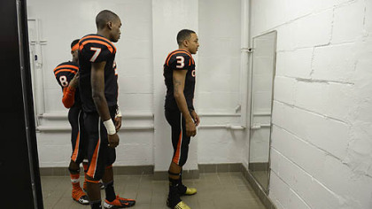 For young, aspiring football players in Clairton, this is the culmination of years of hard work: wearing the orange and black of the varsity team and maybe someday lifting the state championship trophy. From left, Vinny Moody (No. 8), Dakota Halcomb (No. 7) and Bryan Clifford give their uniforms a final check before taking the field in October.