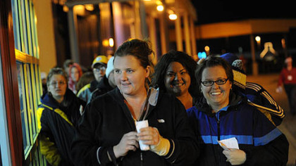 Christi Armstrong, center, of Beaver and her sister Jennifer Daniels-Wells of Butler wait at the front of the line outside Toys R Us in Robinson before the 8 p.m. opening of the store on Thursday, November 22, 2012.