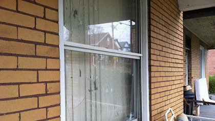 The aftermath of gunfire sprayed on a home in the 600 block of Waddell Avenue, where a family of six was home but no on was injured.