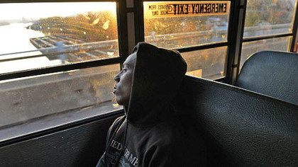 Clairton running back Tyus Booker and his teammates ride in silence as their bus crosses the Monongahela River Nov. 9 on the way to a playoff game in Belle Vernon.