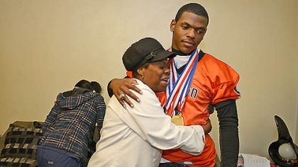 Ann Marie Ford hugs her son Robbie Boatright at their Clairton home. Ford said she is proud of her son and his Bears teammates. They put us on the map, she says.
