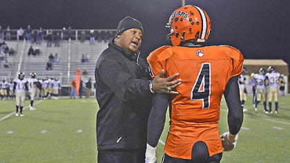 Defensive coordinator Wayne Wade coaches Devante Gardlock during the Bears playoff game against Brentwood Friday, November 9 in Belle Vernon.  Wade, who played for the Bears in the 80s, said he wants to give back to Clairton. "I've always felt compelled to come back  to give back because of the situation ... this is a changed town ... the mill was booming, business was booming.  I think football gives them (players) a sense of hope," he said.