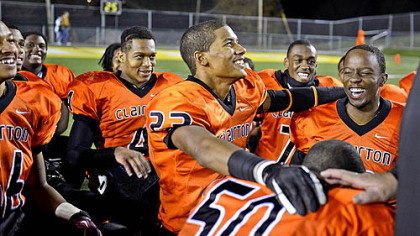 Tyler Boyd, center, and Armani Ford, right, kneel together with their teammates for the Lord's Prayer, a pre- and post-game tradition, after beating Brentwood in the WPIAL Class A quarterfinals, 39-0, in Belle Vernon.