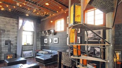 A circular stairway leads to the shipping container third floor from the open second floor in Mayor John Fetterman's home in Braddock, a converted warehouse off Library Street.