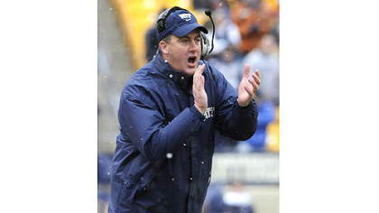 Pitt head coach Paul Chryst applauds his team''s effort against Rutgers in the second quarter this afternoon at Heinz Field.