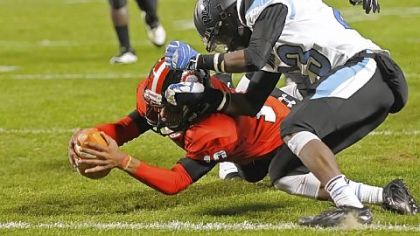 Aliquippa's Malik Shegog dives into the end zone past Washington's Darius Spinks in the WPIAL Class AA championship Friday at Heinz Field.