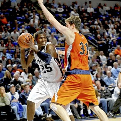 Penn State's Jon Graham looks for an open teammate as he is blocked by Bucknell's Mike Muscala during an NCAA college basketball game, Friday, Nov. 23, 2012, in State College, Pa.
