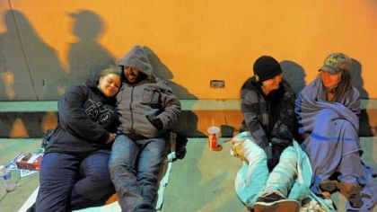 Janice Tates, left, of Ambridge huddles next to her boyfriend, Jasmond Cain of Aliquippa, and Michelle McAbee and her daughter Kaylee Littleton, right, of Follinsbee, WVa., wait outside Toys R Us in Robinson before the 8 p.m. opening of the store.