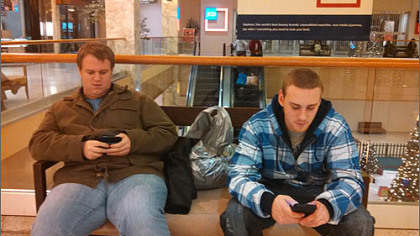 Bobby Walsh, 20, of Monroeville, left, and Garrett Lott, 24, of Penn Hills, take a break from shopping at the Monroeville Mall just after 3 a.m. Both men started their night of shopping more than 6 hours earlier at Wal-Mart.