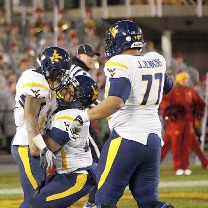 West Virginia wide receiver Tavon Austin, left, celebrates his touchdown with running back Shawne Alston, center, and offensive linesman Josh Jenkins,  in the second half Friday against Iowa State in Ames, Iowa.