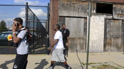 From left, Tyler Boyd, Devonte Harvey and Titus Howard walk through downtown Clairton on their way to the barber shop before Senior Night on Oct. 26.