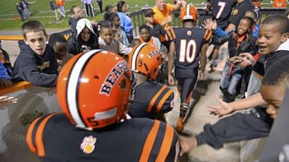The Bears take the field to the cheers of adoring fans before their game against Imani Christian Academy.