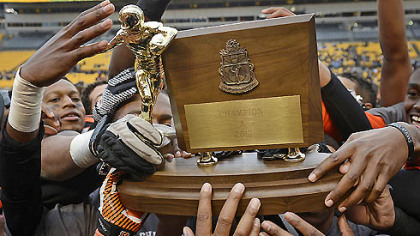 The Clairton Bears raise their WPIAL Class A championship trophy after their 58-21 win over Sto-Rox Friday at Heinz Field secured their 60th consecutive victory and a new state record.