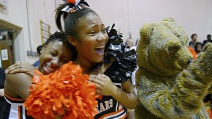Cheerleaders Tori James, 17, left, and Coreiona Wright, 14, laugh while the football players are acknowledged during a pep rally on Nov. 8.