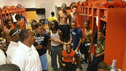 Senior Vinny Moody, 18, center, hypes up his Bears teammates before a home game Oct. 26 against Imani Christian Academy. Moody and other members of the team wrote a rap about their predicted defeat of the Saints. Players listened to the song for hours before kickoff.