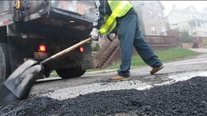 A pothole gets patched.