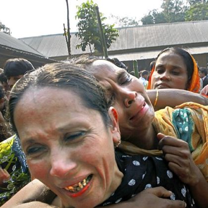 Relatives of garment factory workers killed in a fire cry as they come Sunday to collect bodies from a mortuary in Dhaka, Bangladesh.