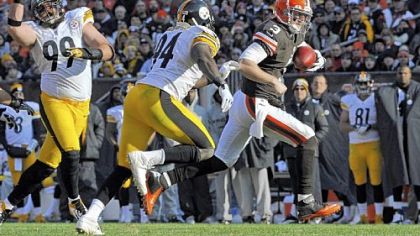 Browns quarterback Brandon Weeden evades Lawrence Timmons in the second quarter Sunday in Cleveland.