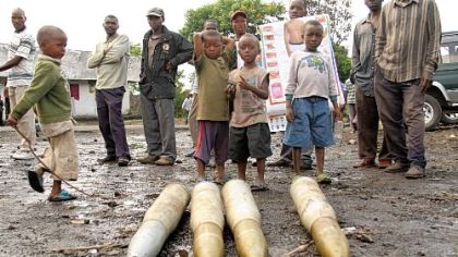Boys look over tank shells left behind Wednesday by retreating government troops as they fled an assault by M23 rebels in eastern Congo.