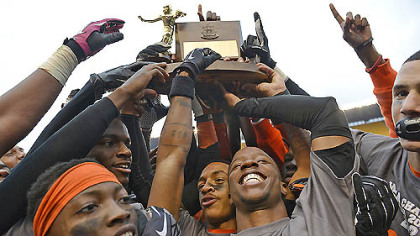 The Bears hold their WPIAL Championship trophy up after their 58-21 win over Sto-Rox Friday at Heinz Field.  The Bears broke a state record, winning their 60th consecutive game.