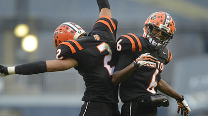 Clairton Bears Santeaun Sims (left) and Titus Howard celebrate Coles touchdown Friday at Heinz Field. The Bears set a Pennsylvania record with its 60th consecutive victory, a 58-21 win against Sto-Rox in the WPIAL Class A title game.