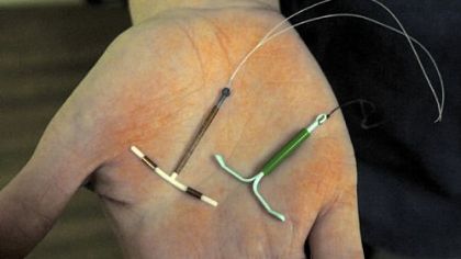 Planned Parenthood lead clinician Katherine Schott holds a copper-based ParaGard IUD, left, and a hormone-releasing Mirena IUD.