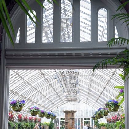 Kim Hoffman of Kilbuck walks into the Sunken Garden room with her sons Garren, 11, left, and Zachary, 9, on Friday, the opening day of Phipps Conservatory and Botanical Garden's Winter Flower Show.